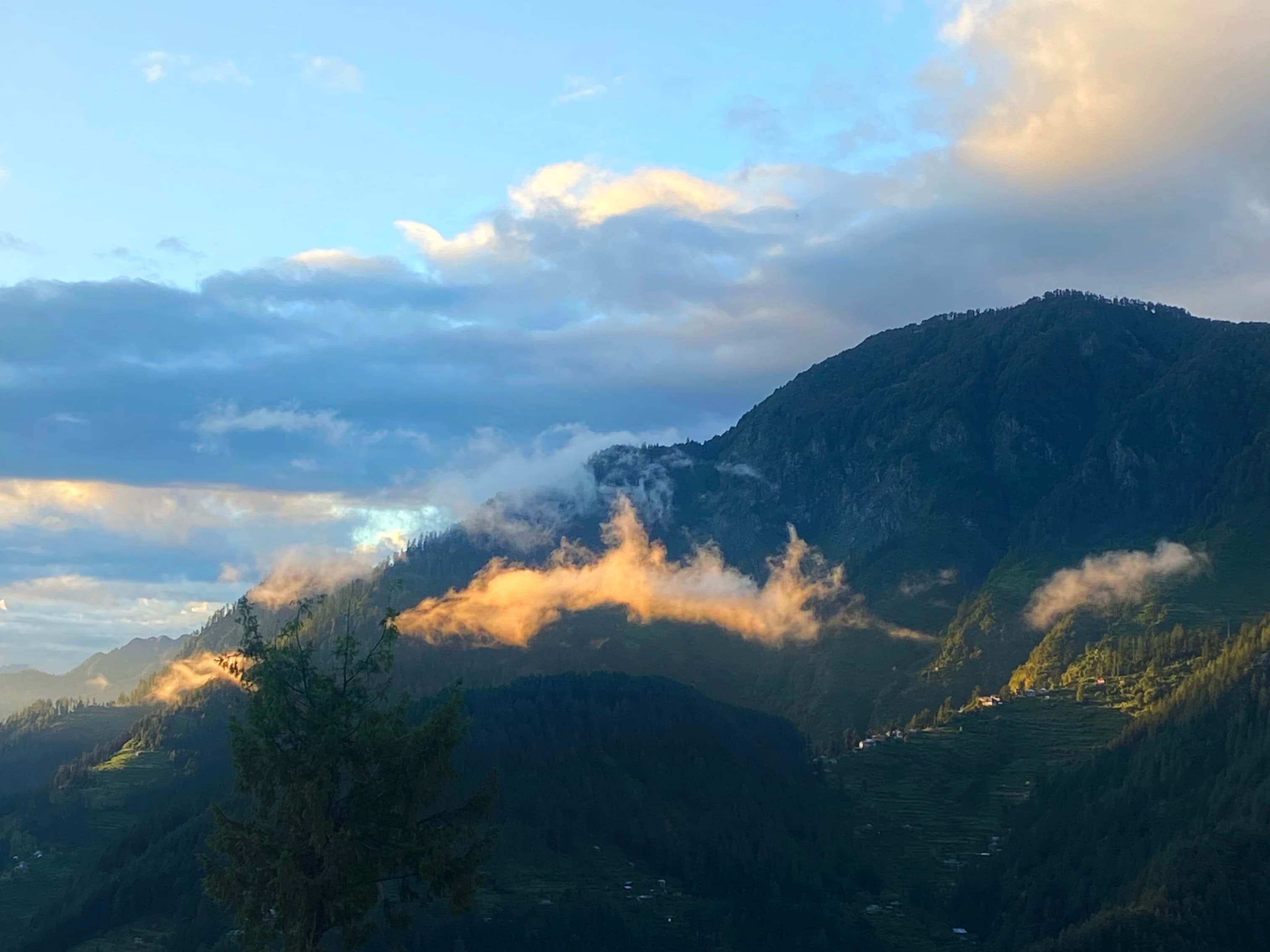 An image of orange clouds on the mountains.
